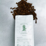 Ritual Balanced coffee bag under a scatter of roasted coffee beans