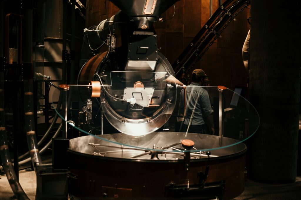 Coffee roaster in a roastery with beans in the cooling tray