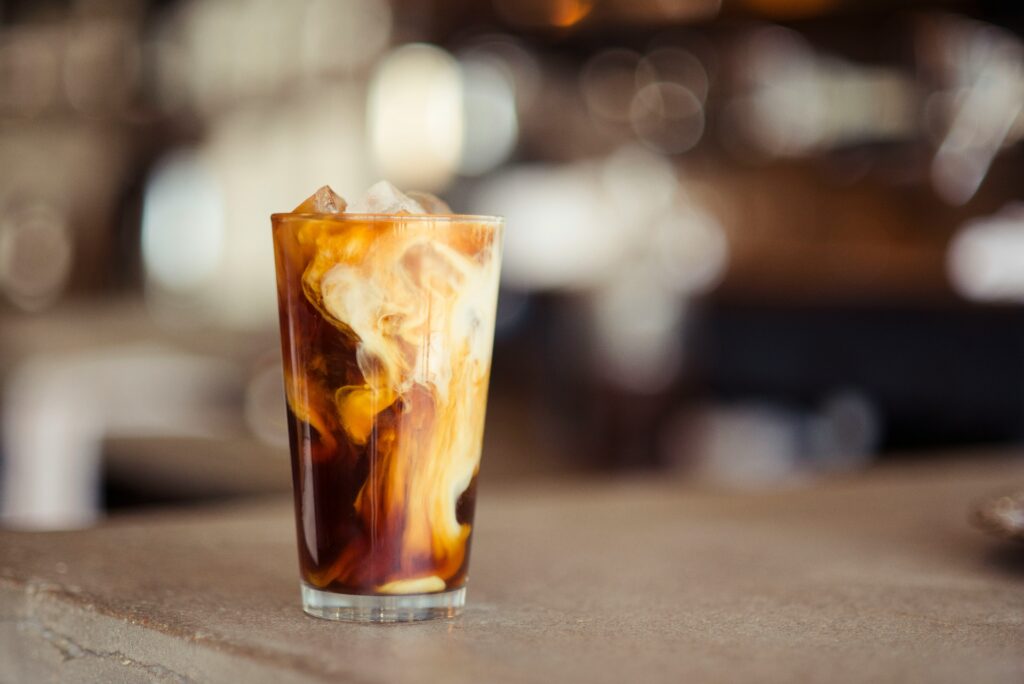 Iced coffee with cream in a tall glass