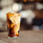 Iced coffee with cream in a tall glass