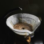 Hot water pouring into a pour-over filter over a glass carafe