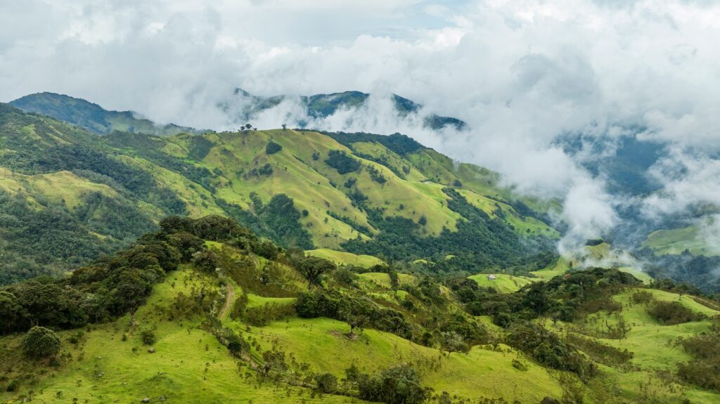 Green mountain ridges under low clouds